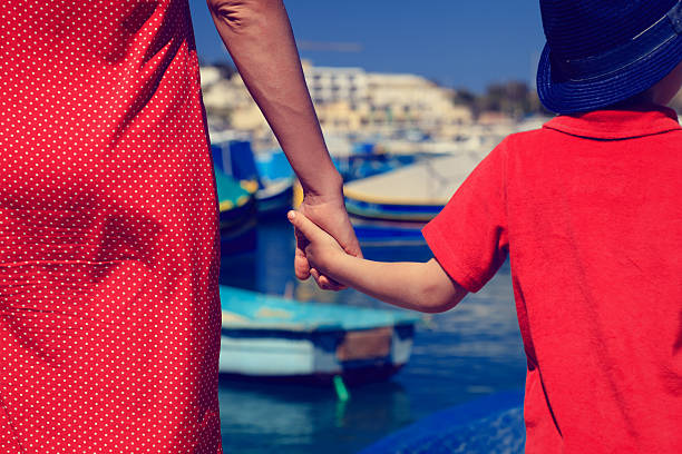 istock mother and son holding hands in the port 500833414