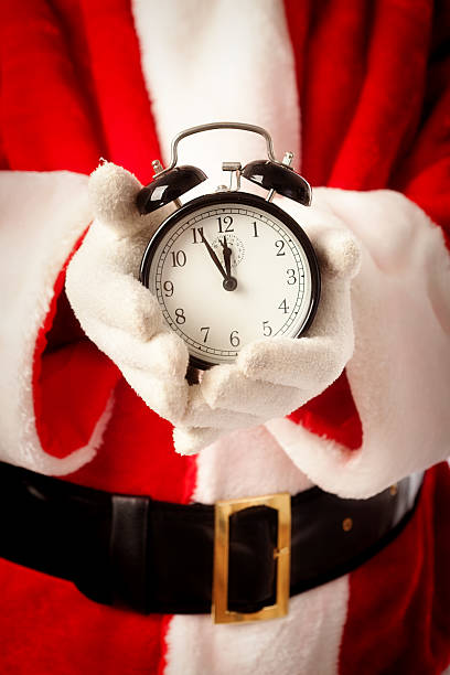 istock Santa Claus Holding Shopping Deadline Alarm Clock Vertical 500833571