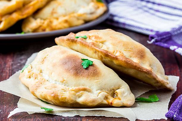 Mini calzone, closed pizza, Italian pastry stuffed with cheese
