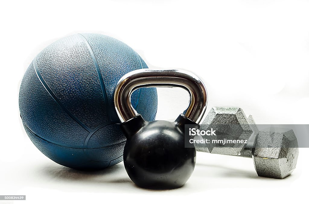 Sports-Kettlebell-medicine ball-dumbbells Black and silver kettlebell, blue medicine ball, and silver dumbbells Exercise Equipment Stock Photo