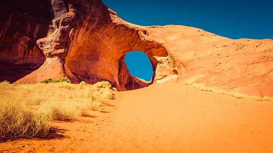 Monument Valley is a region of the Colorado Plateau characterized by a cluster of vast sandstone buttes, the largest reaching 1000 ft above the valley floor.