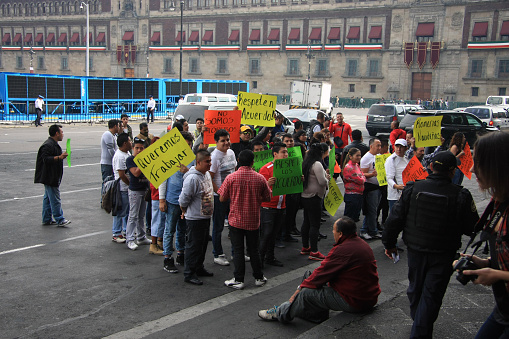 Mexico City, Mexico - November 24, 2015: Large group of young protesters in Zocalo Square, Mexico City