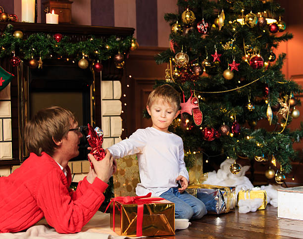 istock father and son giving presents at Christmas 500837128