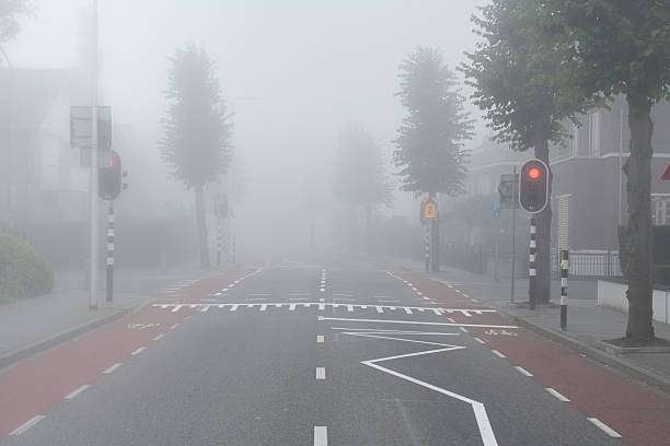 istock Red light and fog on intersection in small rural town 500837716