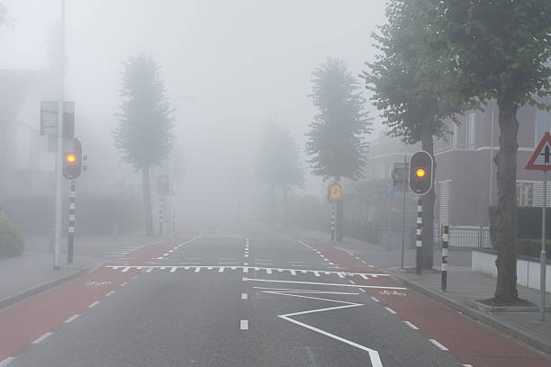 istock Amber light and fog on intersection in small rural town 500837750