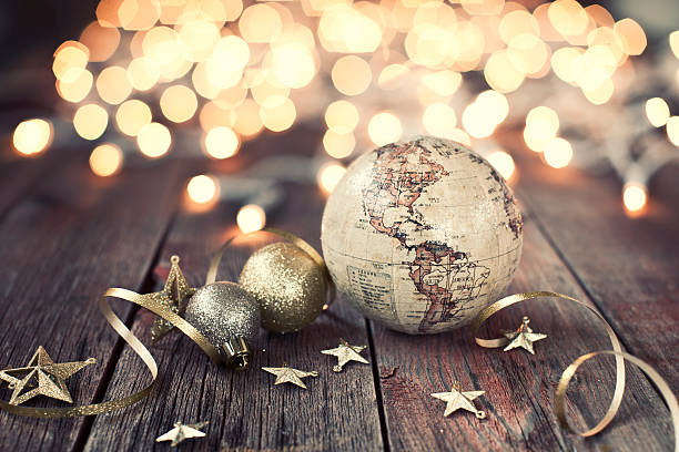 istock Christmas Globe, Lights, Baubles and Decorations on Old Wood Background 500838012