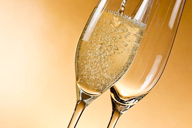 istock empty glasses of champagne and one being filled 500839004