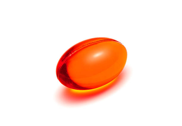 istock Red transparent supplement capsule isolated on white background 500839608