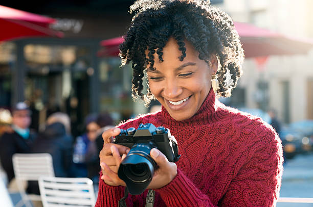 istock Woman looking at pictures in camera 500839680