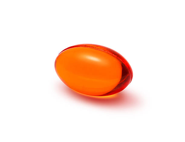 istock Red transparent supplement capsule isolated on white background 500839912