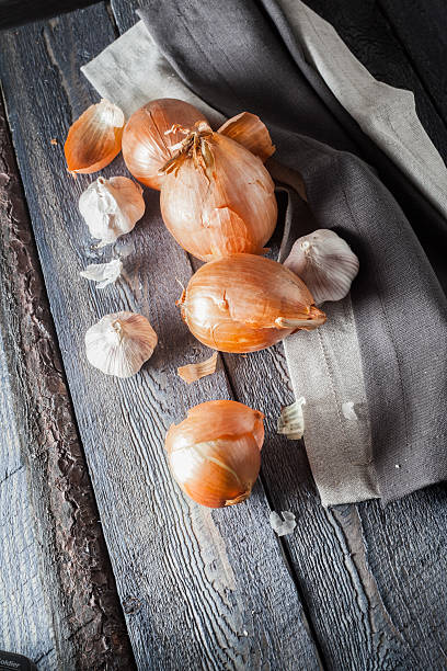 istock Sack with onions on a wooden background. 500840650