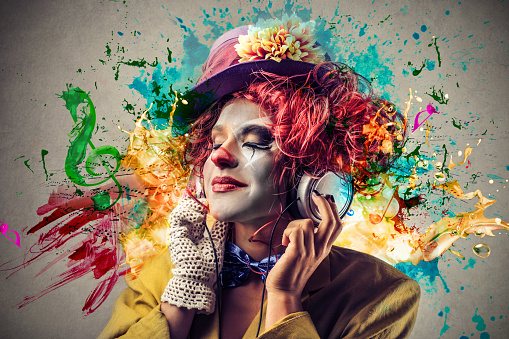 Woman dressed as a colorful clown listening to music with colorful illustrations