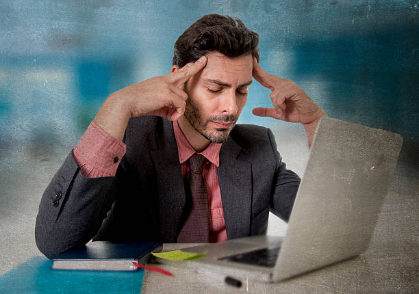 istock businessman with headache working on computer desperate in work stress 500842196