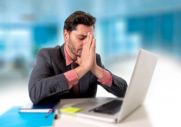 istock businessman with headache working on computer desperate in work stress 500843284