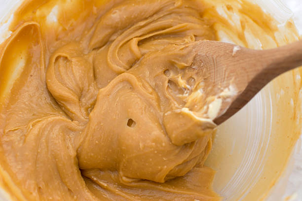 istock Peanut butter and butter with a wooden spoon 500843546