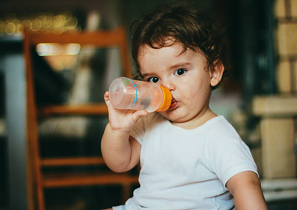 istock Cute baby drinking water 500844136
