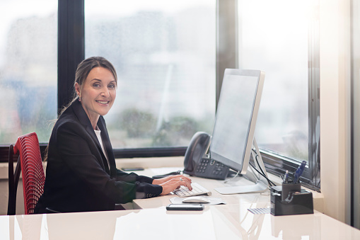 Business woman showing laptop blank screen.