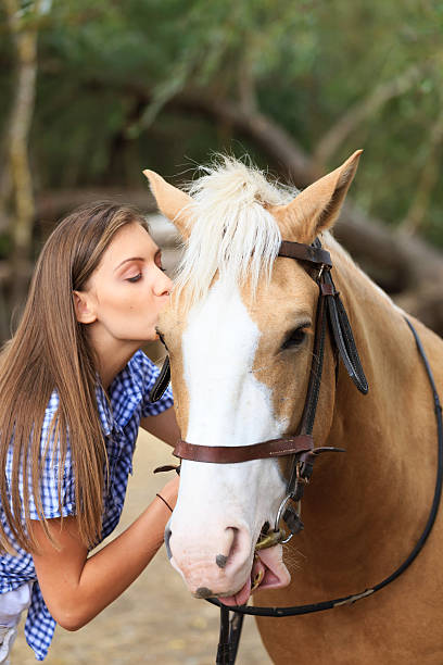 istock Young rider kissing her horse 500845178