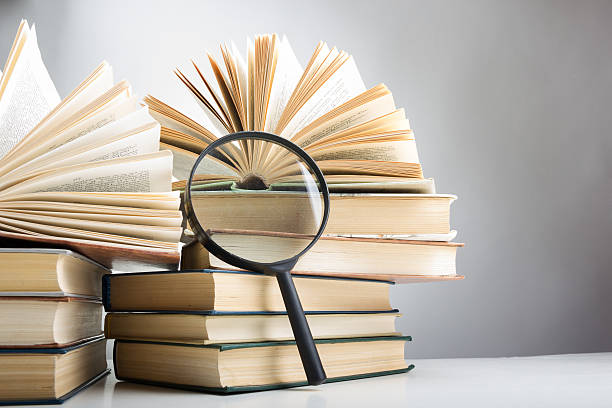 istock Composition with hardback books and magnifying glass..Education background. 500845680