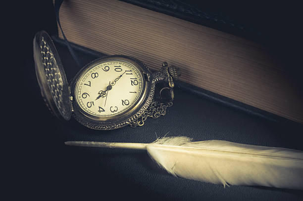 istock Pocket watch with feather and book. 500846210