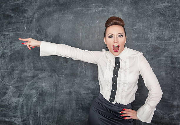 istock Angry screaming teacher pointing out 500847599