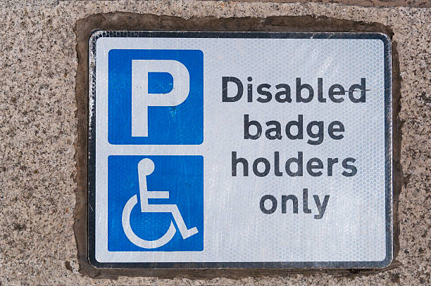 istock Disabled badge holders parking only sign on concrete warning motorists 500850543