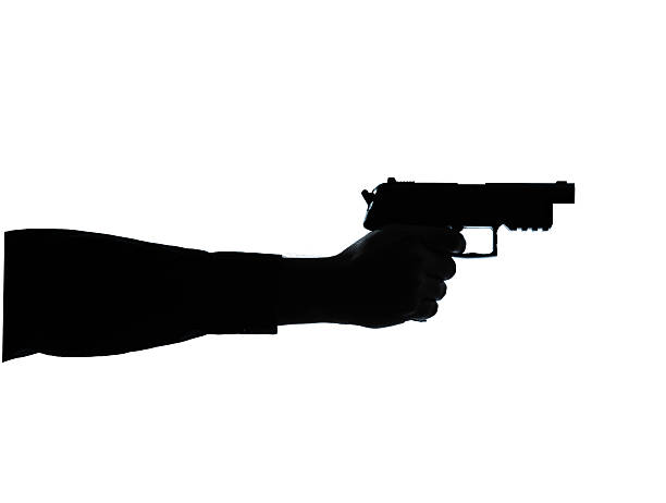 istock close up detail one man hand aiming gun silhouette 500853125