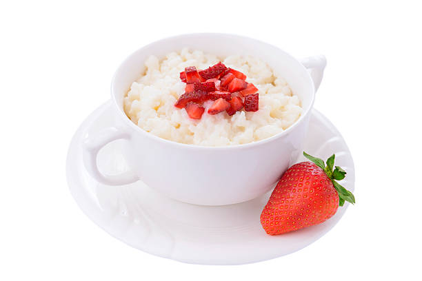 Rice pudding with fresh strawberry on white background Rice pudding with fresh strawberry on white background isolated on whie stock pictures, royalty-free photos & images