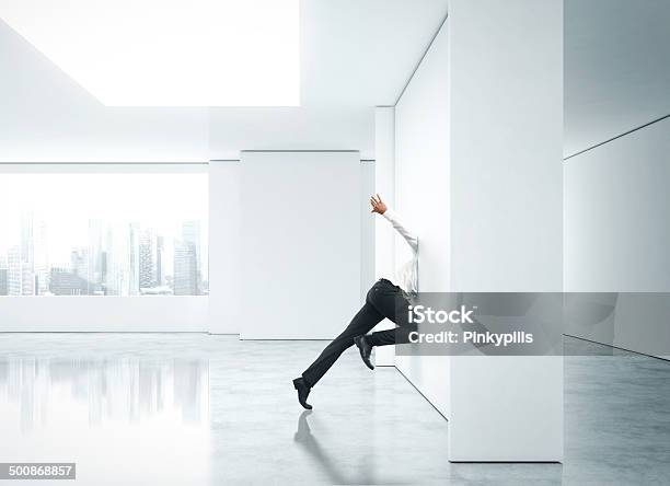 Businessman Getting Stuck Into Office Wall Stock Photo - Download Image Now - Adult, Aspirations, Bizarre