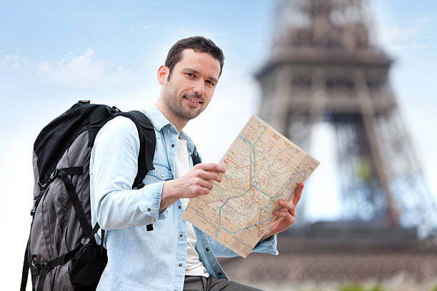 istock Young attractive tourist reading map in Paris 500869193