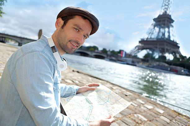 istock Young attractive tourist reading map in Paris 500869225