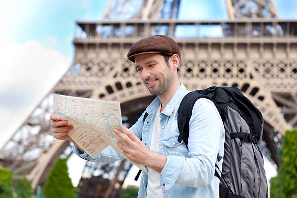 istock Young attractive tourist reading map in Paris 500869235