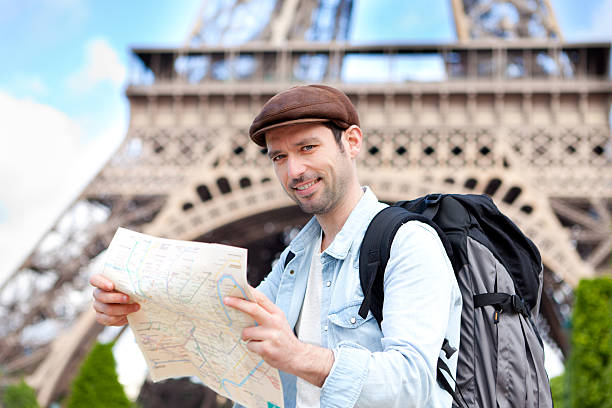 istock Young attractive tourist reading map in Paris 500869237