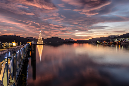 Christmas tree on Lake Woerthersee during colorful sunset. Austria, Carinthia .