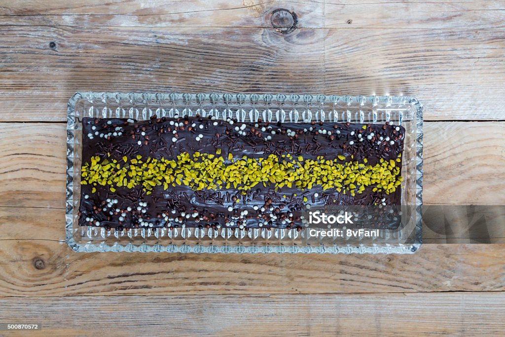 Chocolate cake with pistachio on raw wood Chocolate cake with pistachio on raw wood. 2015 Stock Photo