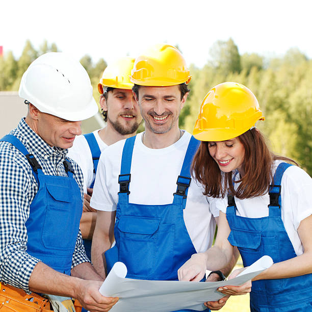 istock Team of workers look at blueprint 500870812