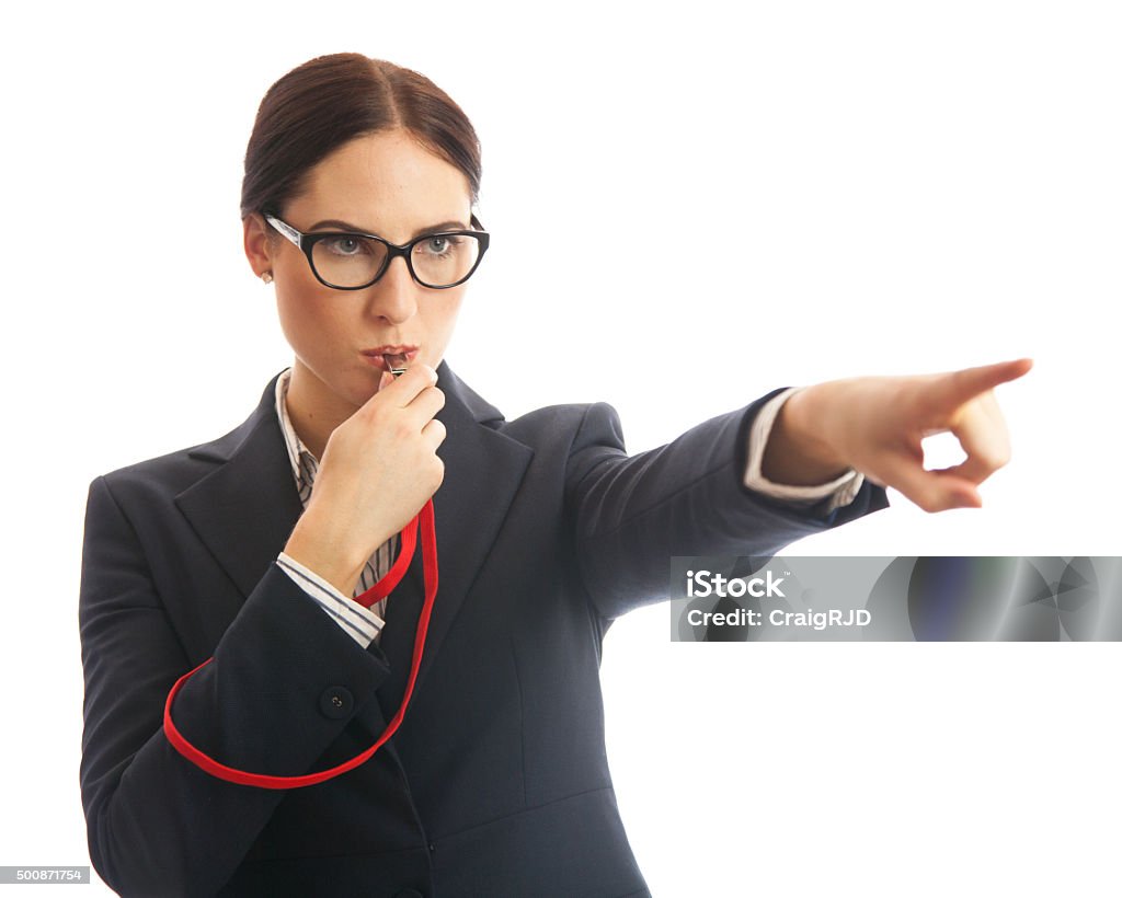 Corporate Whistle Blower Waist up image of a business woman blowing a whistle and pointing. Concept for corporate whistle blower or industry regulator. She is dressed in formal business attire. Studio shot on a white background. Whistleblower - Human Role Stock Photo