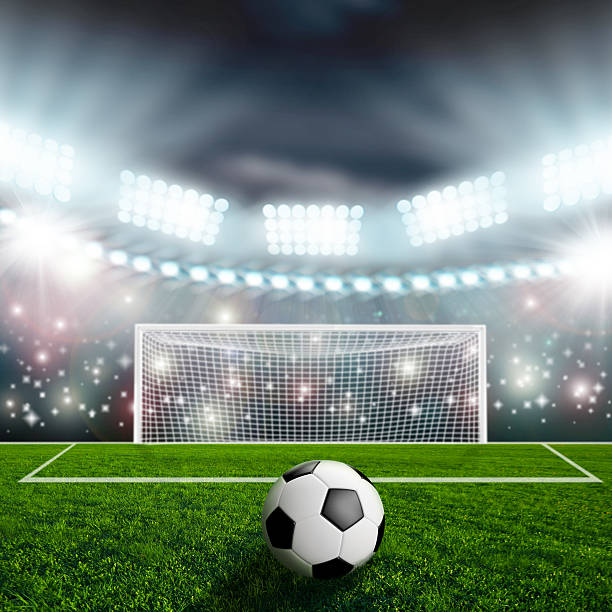 istock Soccer ball on green stadium arena 500873025