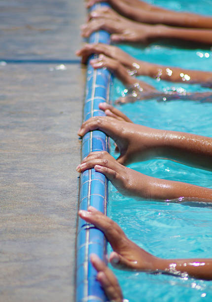 istock hand touching border of pool 500873461