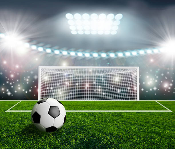 istock Soccer ball on green stadium arena 500874027