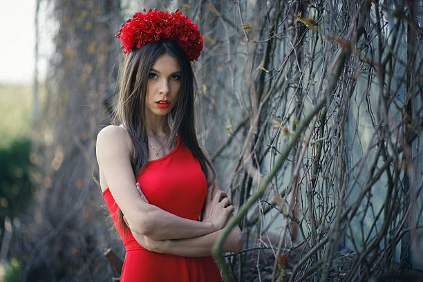istock Young pretty girl is posing with flowers 500874307