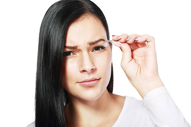 istock plucking tweezers brow 500874356