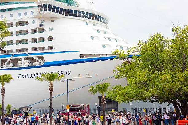Sydney, Australia - November 29, 2015: Passengers waiting to board for cruise ship. Explorer of The Seas Royal caribbean cruise ship is a large ship, carrying 3114 passengers and 1185 crew. The overseas passenger terminal is located at Circular quay with dazzling uninterrupted views of the Sydney Opera House, Sydney Harbour and city skyline.