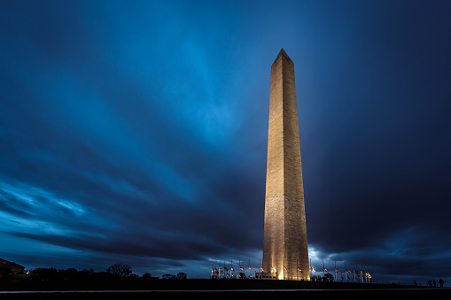 Washington Monument at night with dramatic clouds