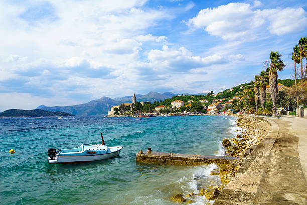 Lopud Beach and Port View of the fishing port and the beach, with cafes, boats, in the village Lopud, Lopud Island, one of the Elaphiti Islands, Croatia dubrovnik lopud stock pictures, royalty-free photos & images