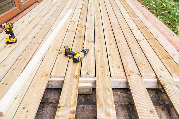 Wooden decking construction. A new wooden, timber deck being constructed. it is partially completed. two drill can be seen on the decking. decking stock pictures, royalty-free photos & images