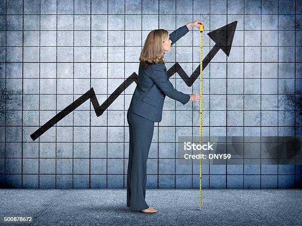 Businesswoman Measures Growth With Tape Measure Stock Photo - Download Image Now - Measuring, Success, Business