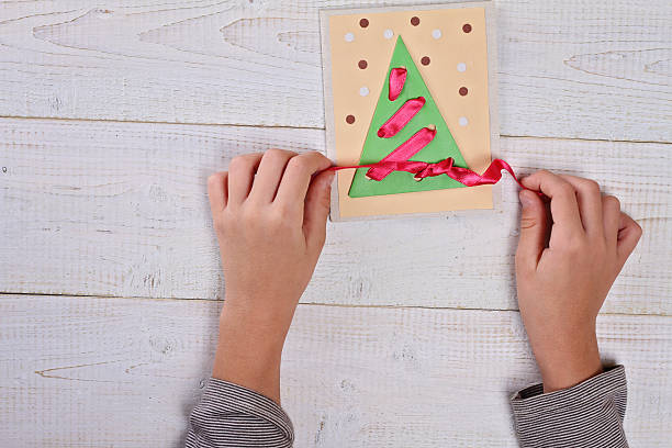 istock Child   making Christmas Tree from colored paper. 500879296