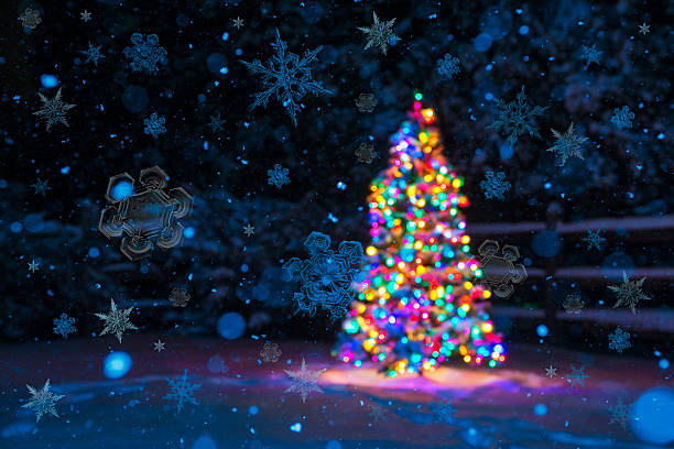 istock Snowflakes falling with Christmas Tree in background 500879466