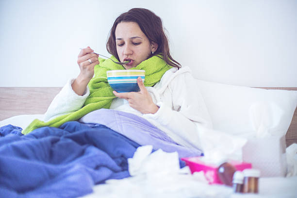 istock Eating chicken noodle soup in bed while sick 500881082